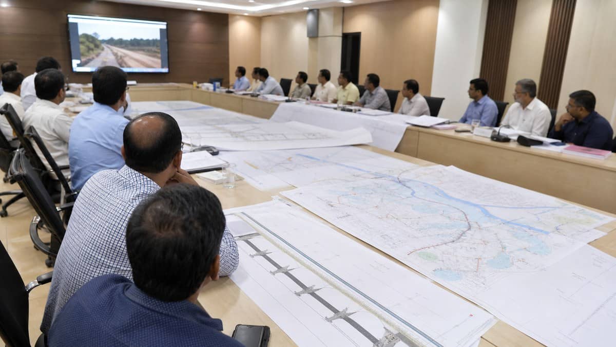 District officials reviewing road and bridge project maps in a meeting room