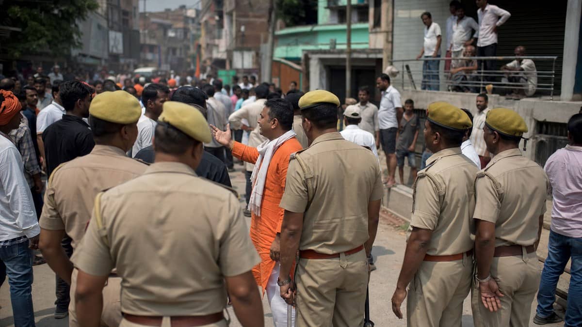 Police and political workers facing each other during a tense public gathering in Varanasi
