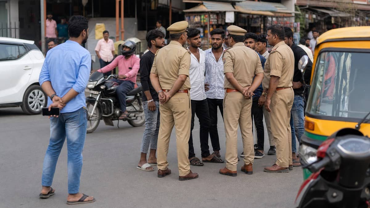 Police speaking with young men on a Varanasi street after an alleged altercation