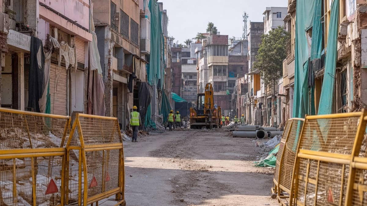 Debris and cleared structures along a Varanasi road widening project site