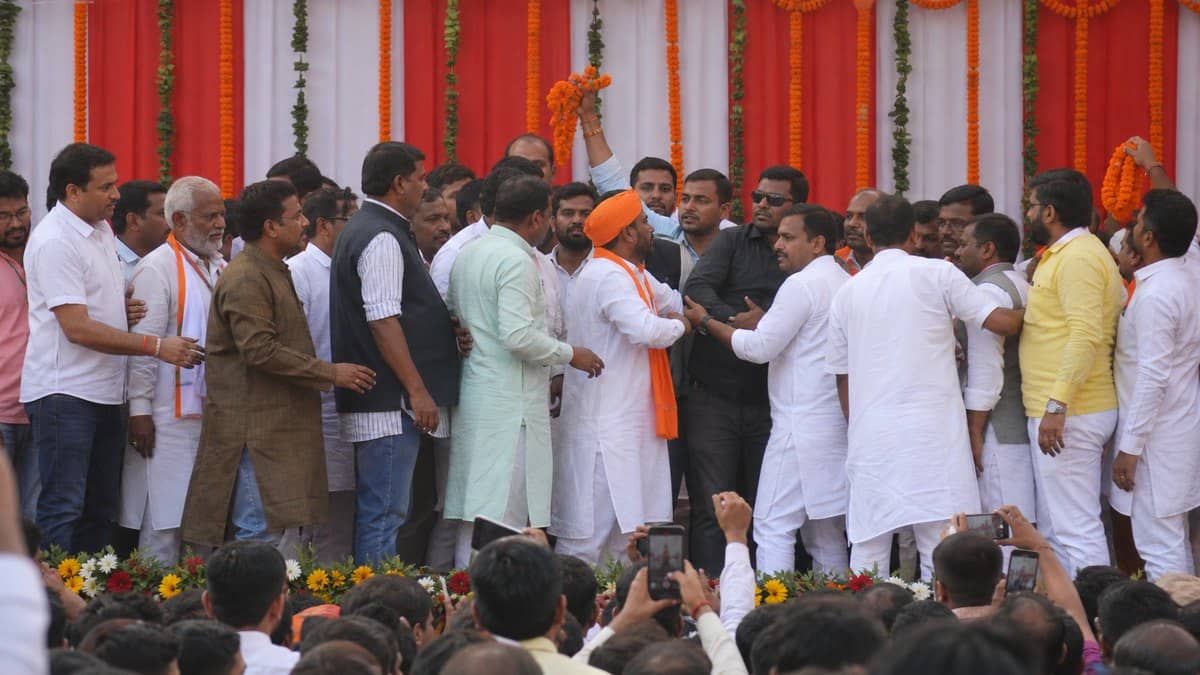 Party workers gathered near a decorated political event stage in Varanasi