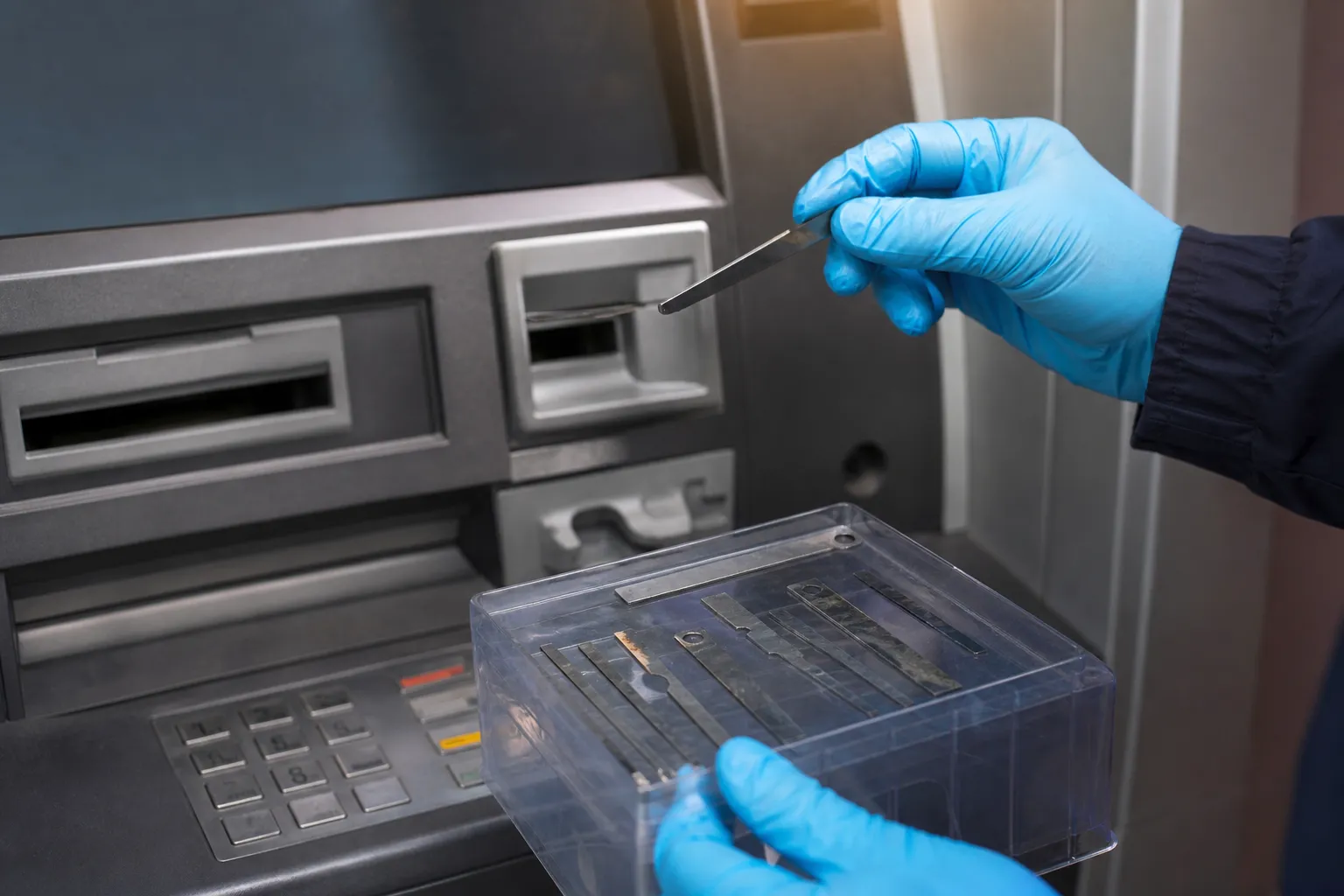 Representative ATM fraud investigation showing metal strips in an evidence tray