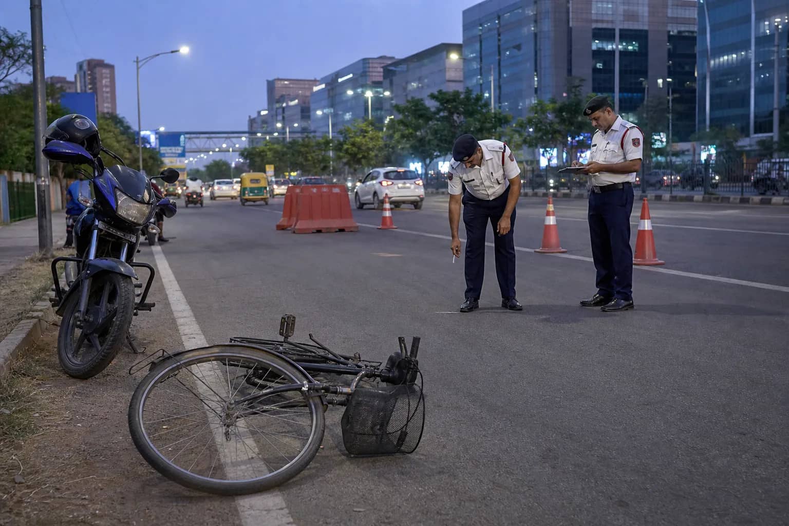 A bicycle beside a barricaded lane on Golf Course Road in Gurugram after a crash