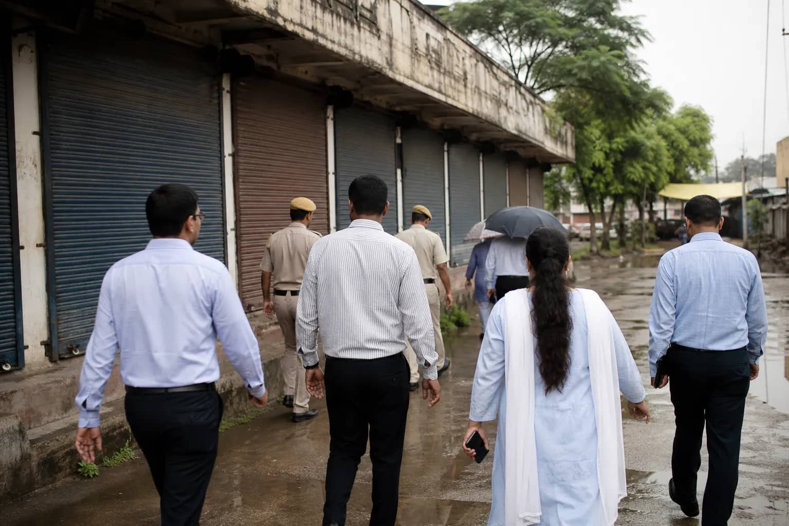 Closed commercial shutters at an HSVP market in Gurugram