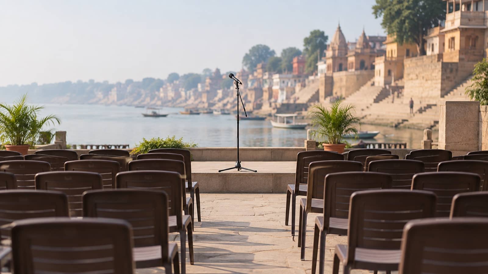 Representative image of empty chairs and a microphone at a generic riverside meeting space