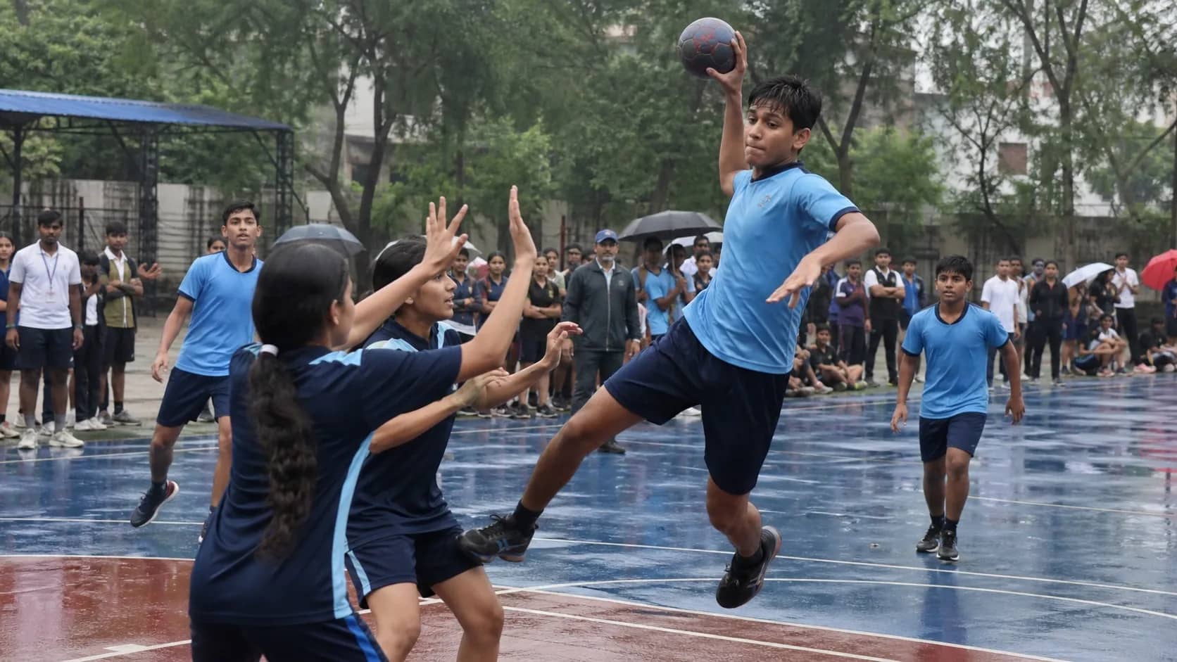 School handball players competing on an outdoor court at Baralalpur in Varanasi