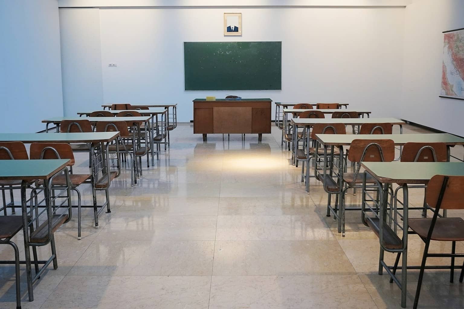 Representational illustration of an exam hall desk with admit card folder and laptop in an Indian academic setting