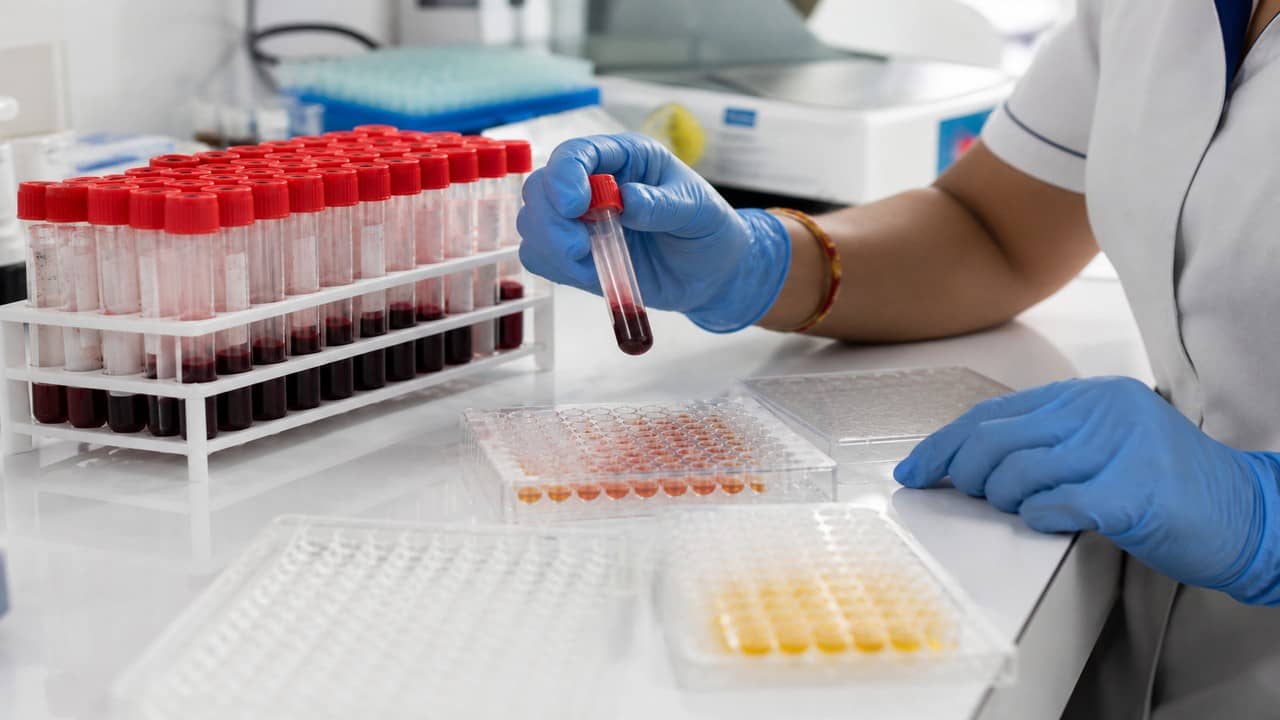 Illustrative clinical laboratory bench with sealed sample vials and soft-focus equipment, no readable labels