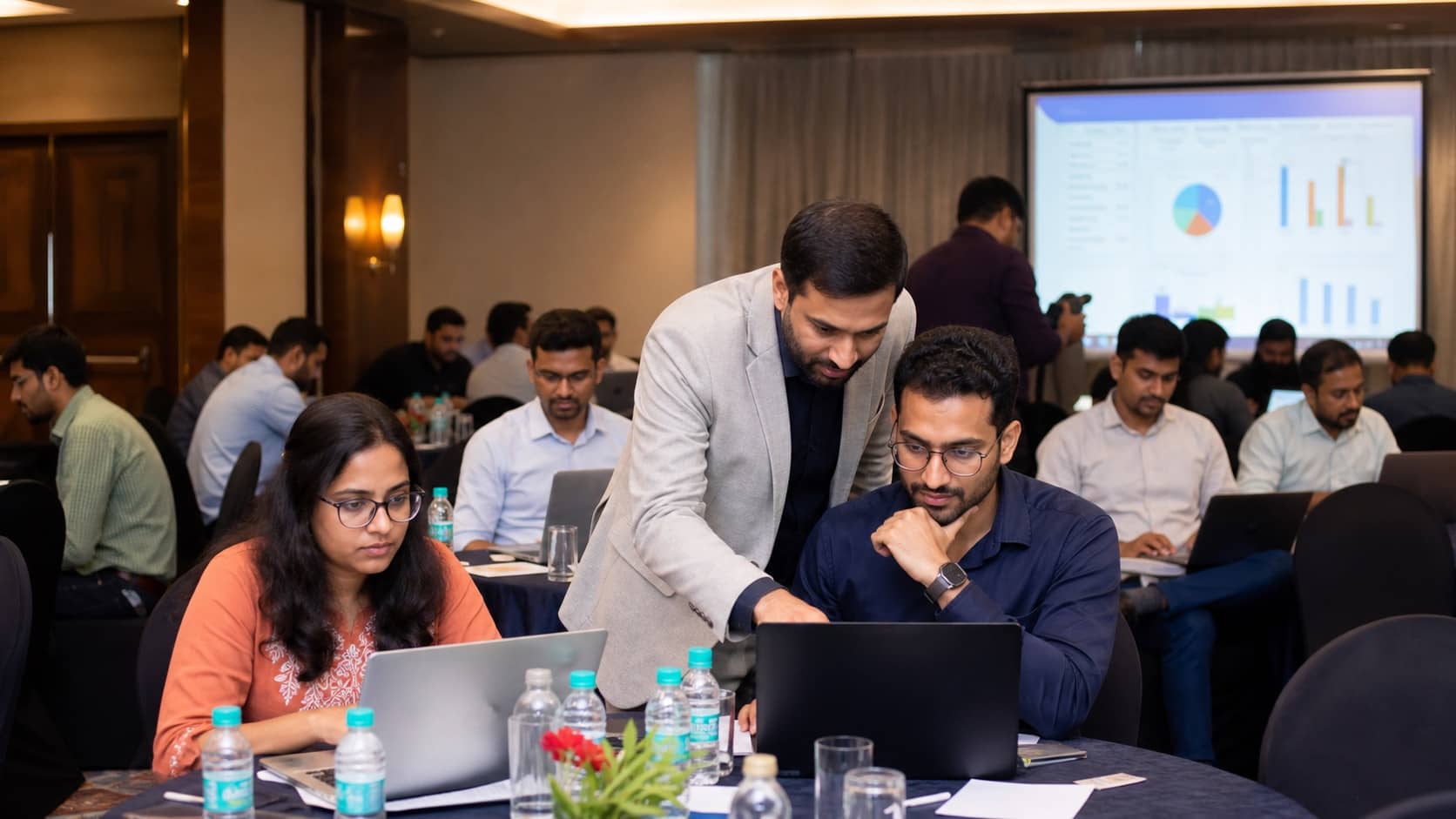 Professionals using laptops at a business systems workshop