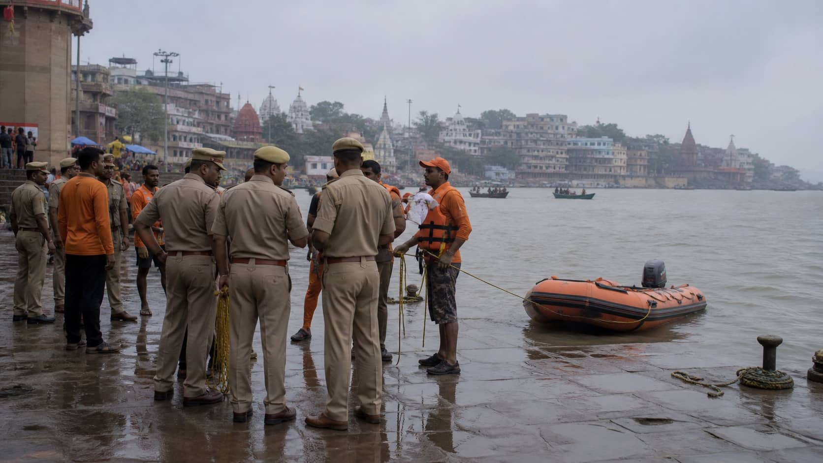 Police and rescue workers beside the Varuna River near a ghat