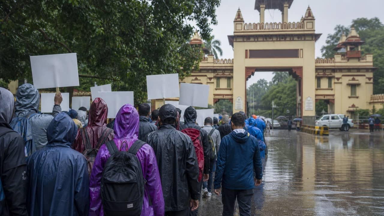 A peaceful civic protest beside a waterlogged city road