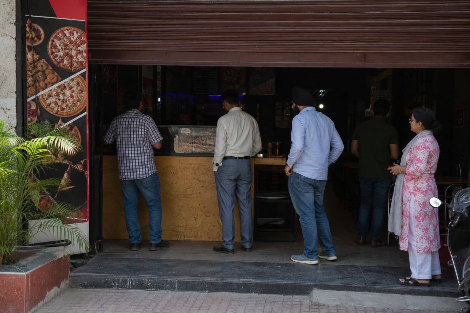 A neighbourhood commercial shopfront on a Gurugram sector road