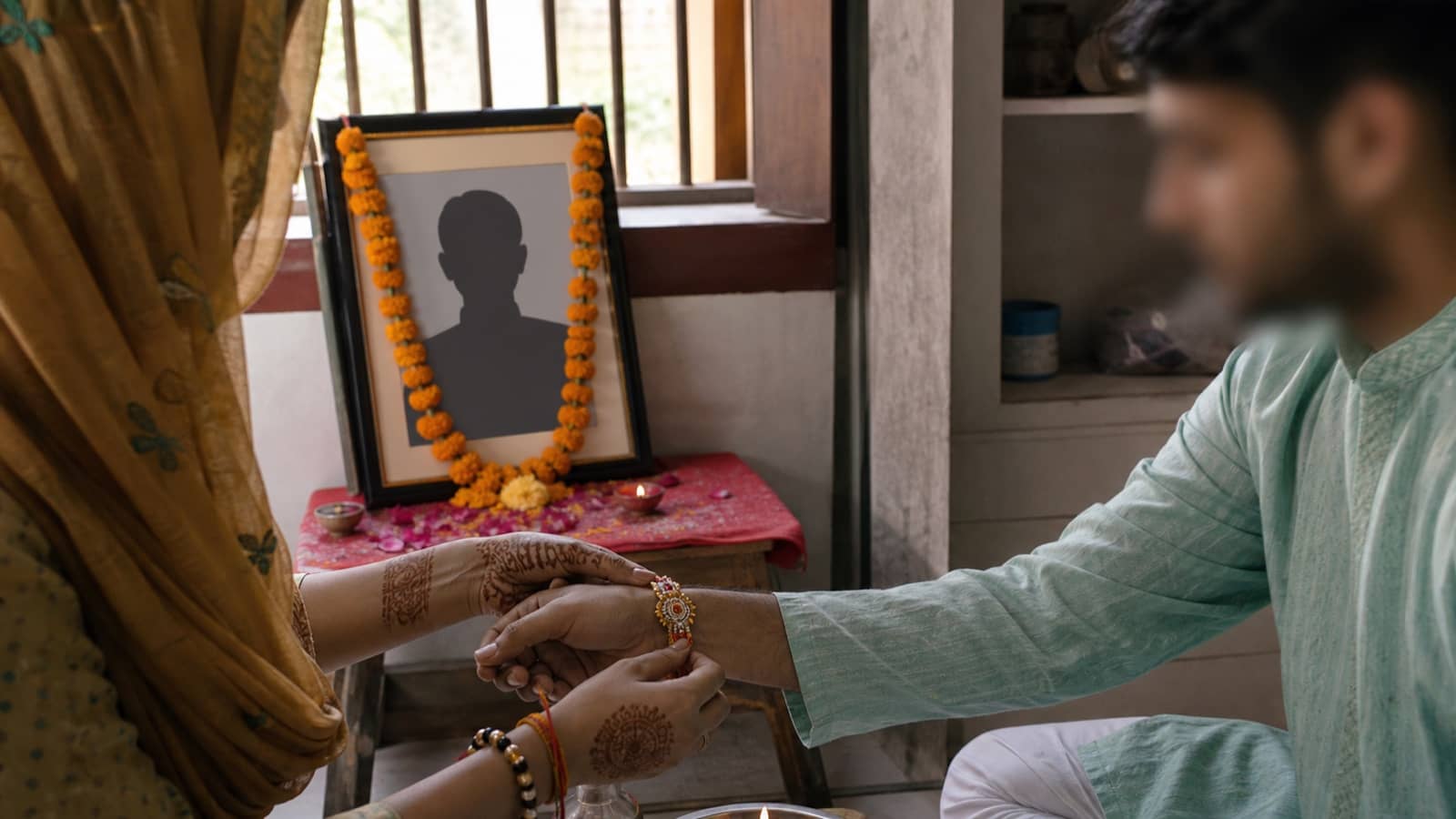 A Raksha Bandhan thread being tied during a memorial family visit in Varanasi