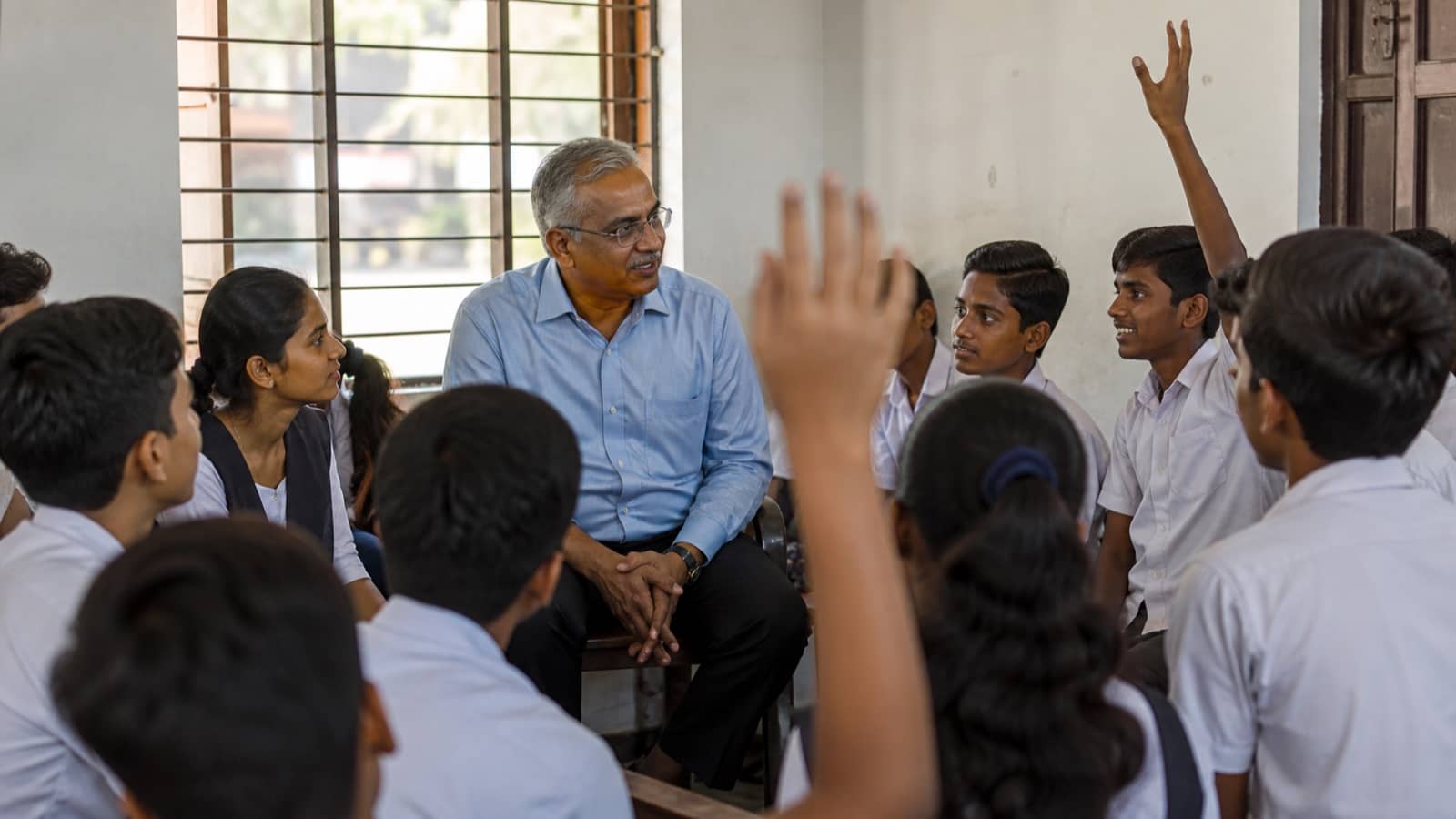 Students asking career questions during a classroom dialogue with a civil administrator in Varanasi