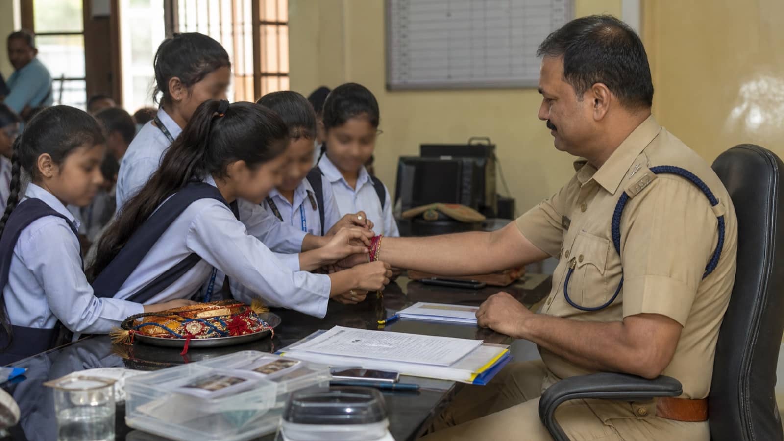 Children tying rakhis during a community visit to a public officer in Varanasi