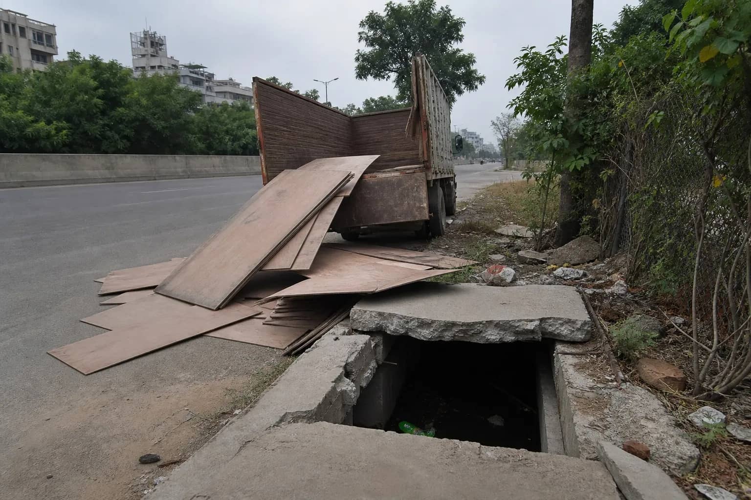 Truck with wheels in an open roadside drain