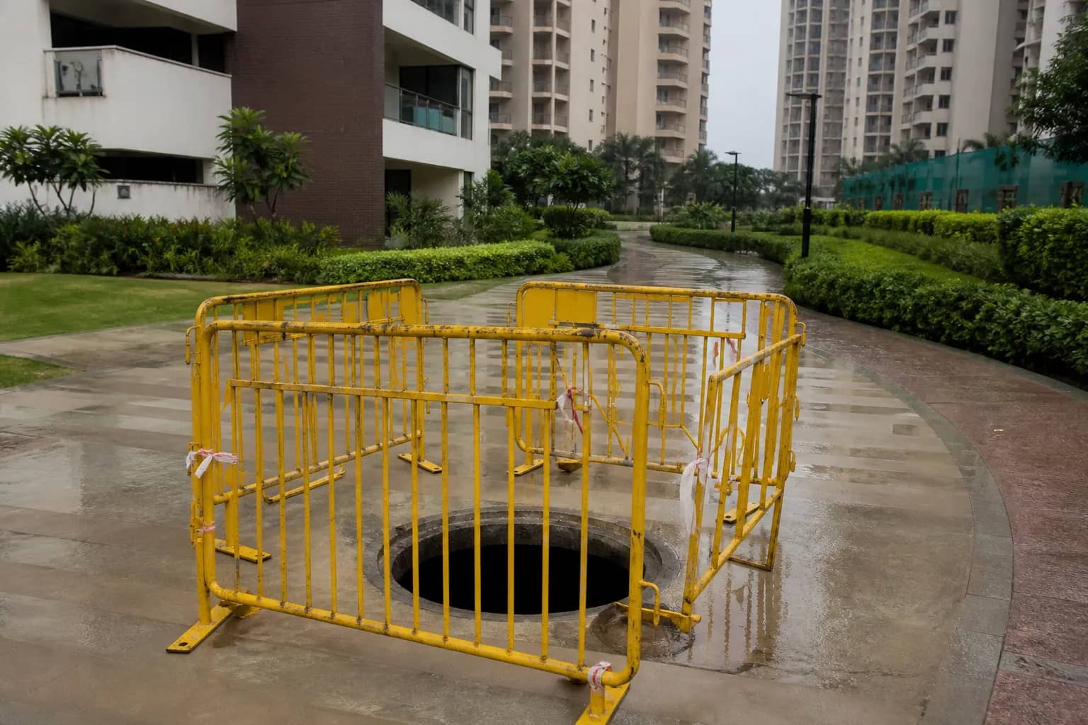 Barricaded open drainage manhole inside a Gurugram residential complex