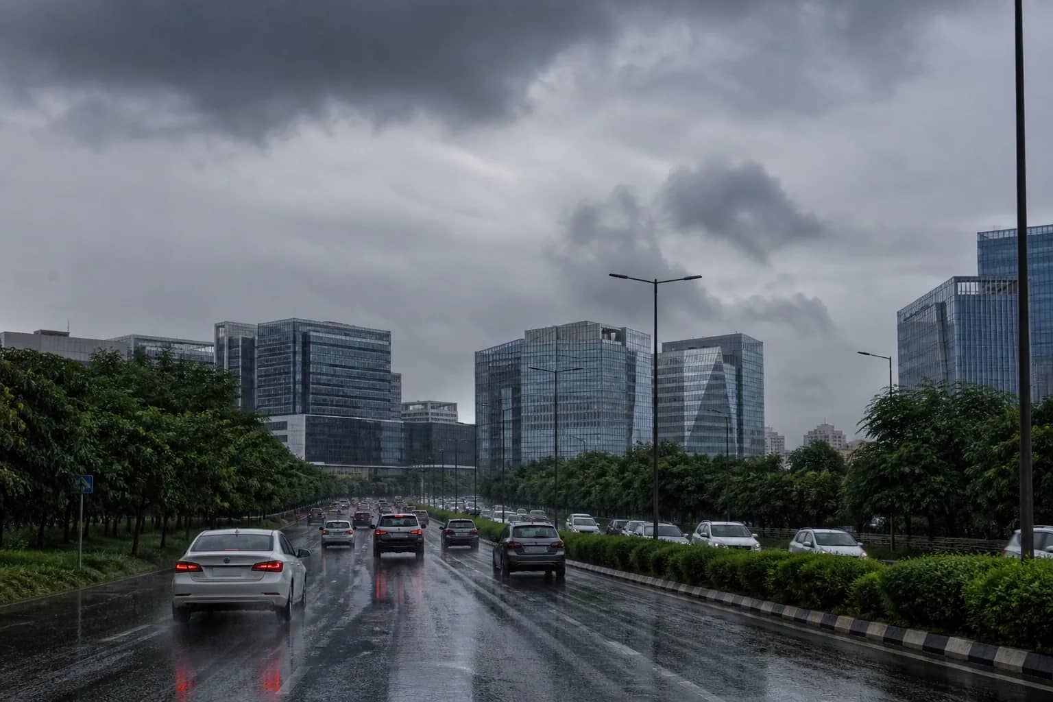 Monsoon clouds and wet traffic on a broad Gurugram road