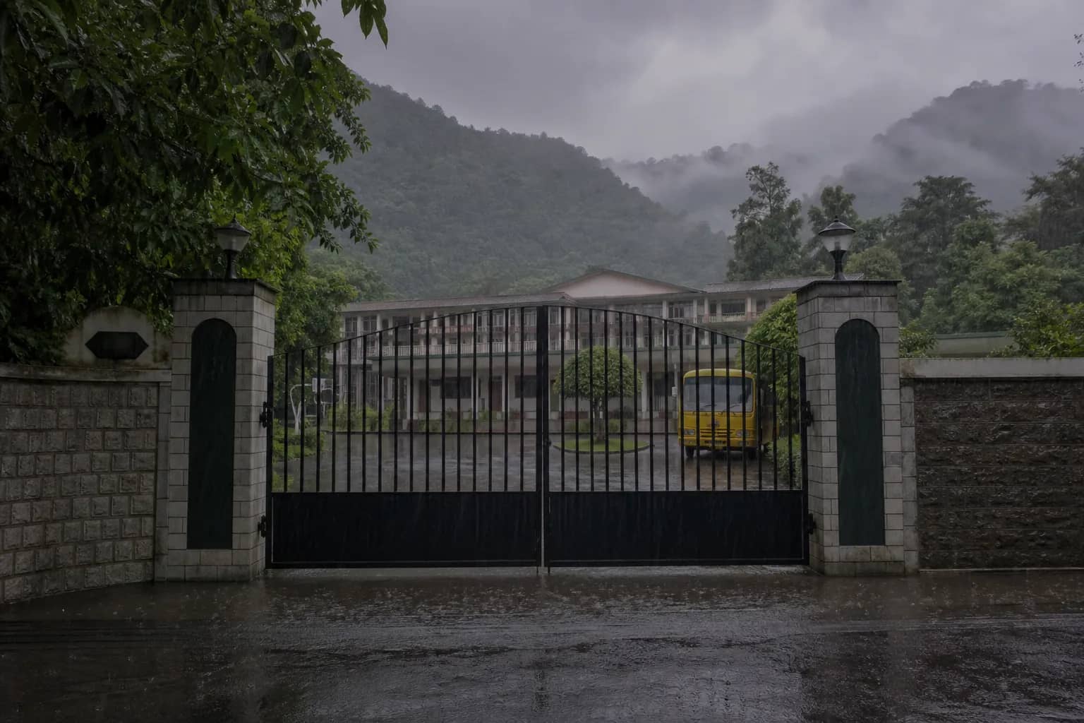 Closed school gate in Dehradun during heavy monsoon rain