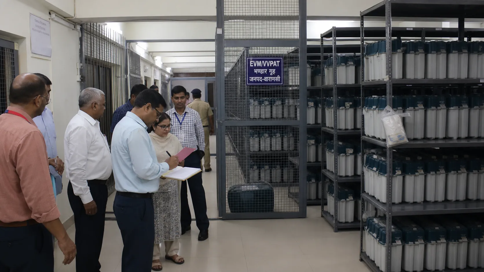 Sealed EVM storage racks being inspected by election officials