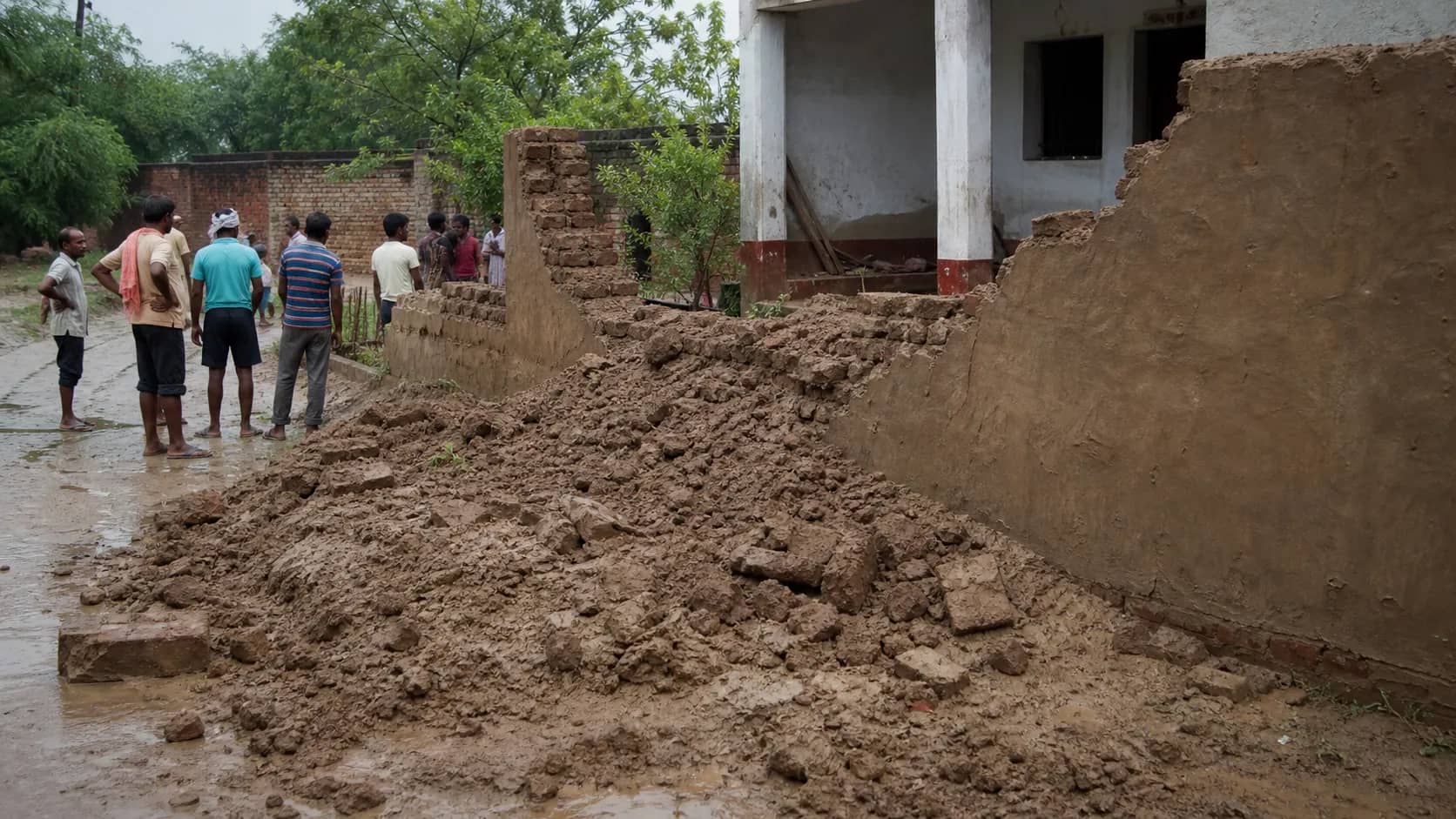 Collapsed earthen wall of a rural home after heavy rain