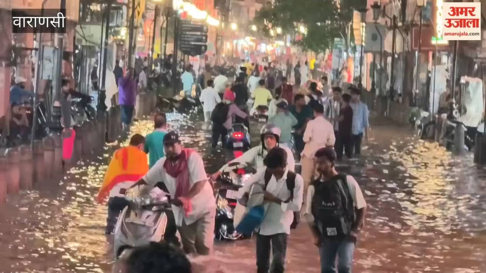 Vehicles moving through rainwater at Godowlia crossing in Varanasi