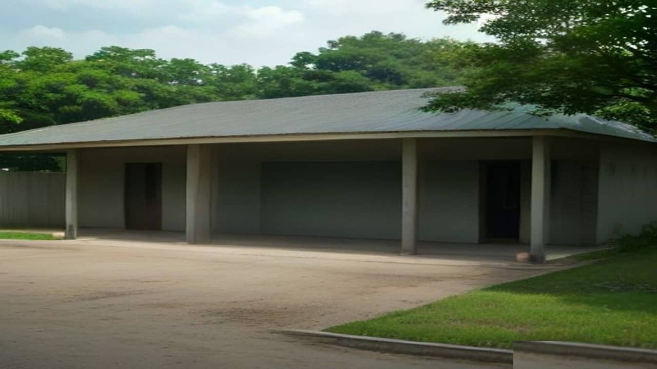Empty rural north Indian police station compound with a plain single-storey building, quiet courtyard and overcast daylight, no people, no vehicles, no readable signboards or logos