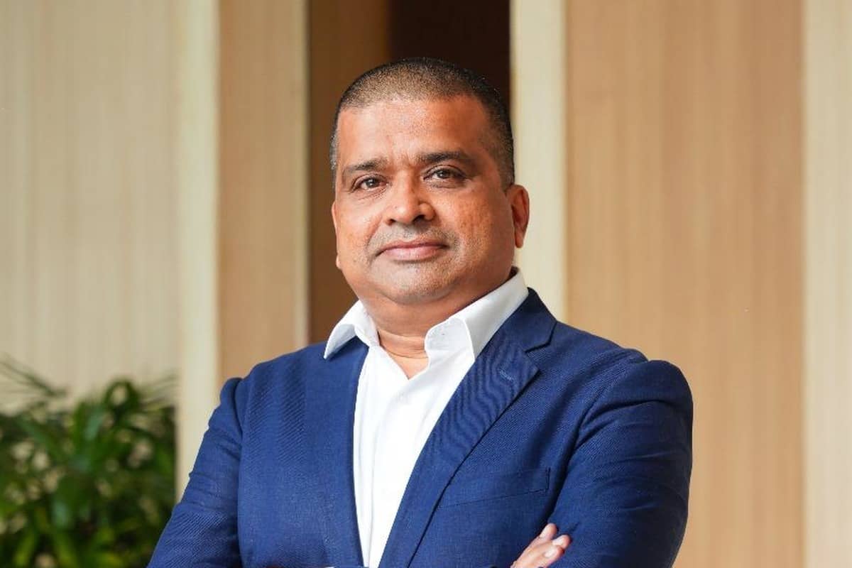 BigEndian Semiconductors executive Mandar Mungee in a blue blazer and white shirt with arms folded, standing in an office with wooden panels