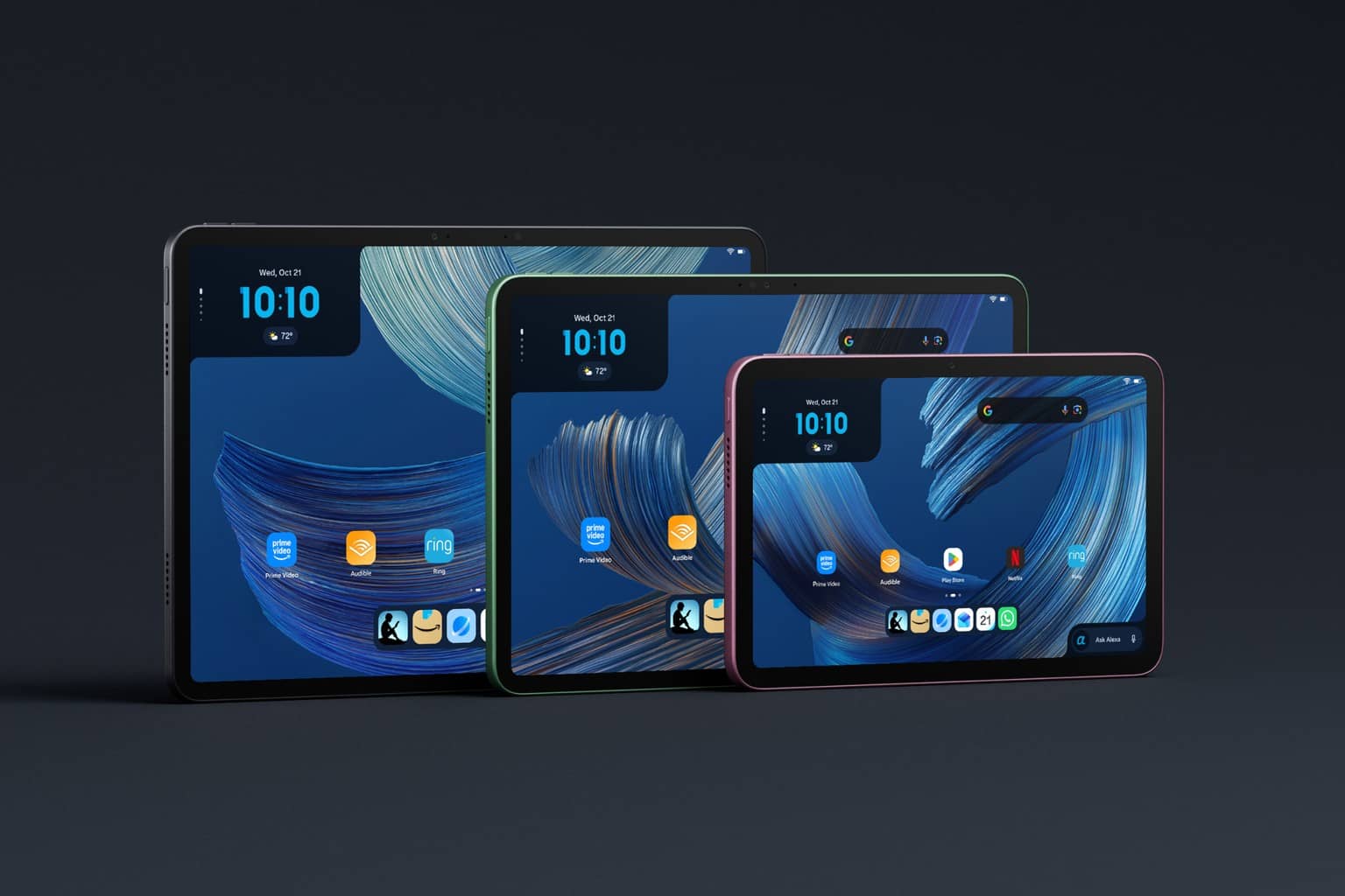 Three Amazon Alexa Tablets of different sizes stand side by side on a dark background, each screen showing a blue swirl wallpaper, a clock and app icons