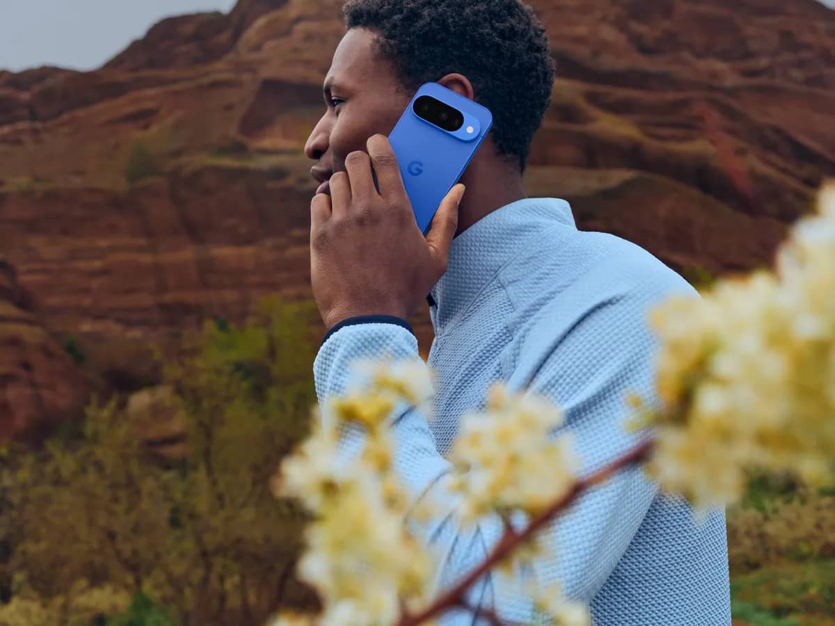 A person using an Indigo Google Pixel 10 outdoors