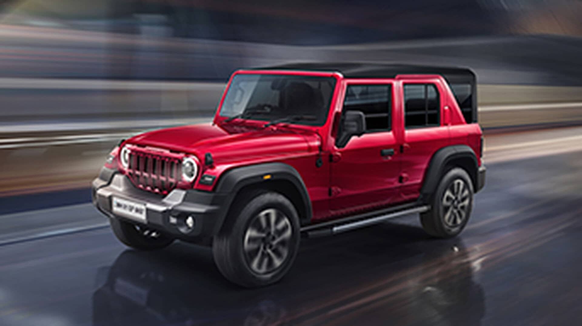 Red Mahindra Thar Roxx SUV driving on a road