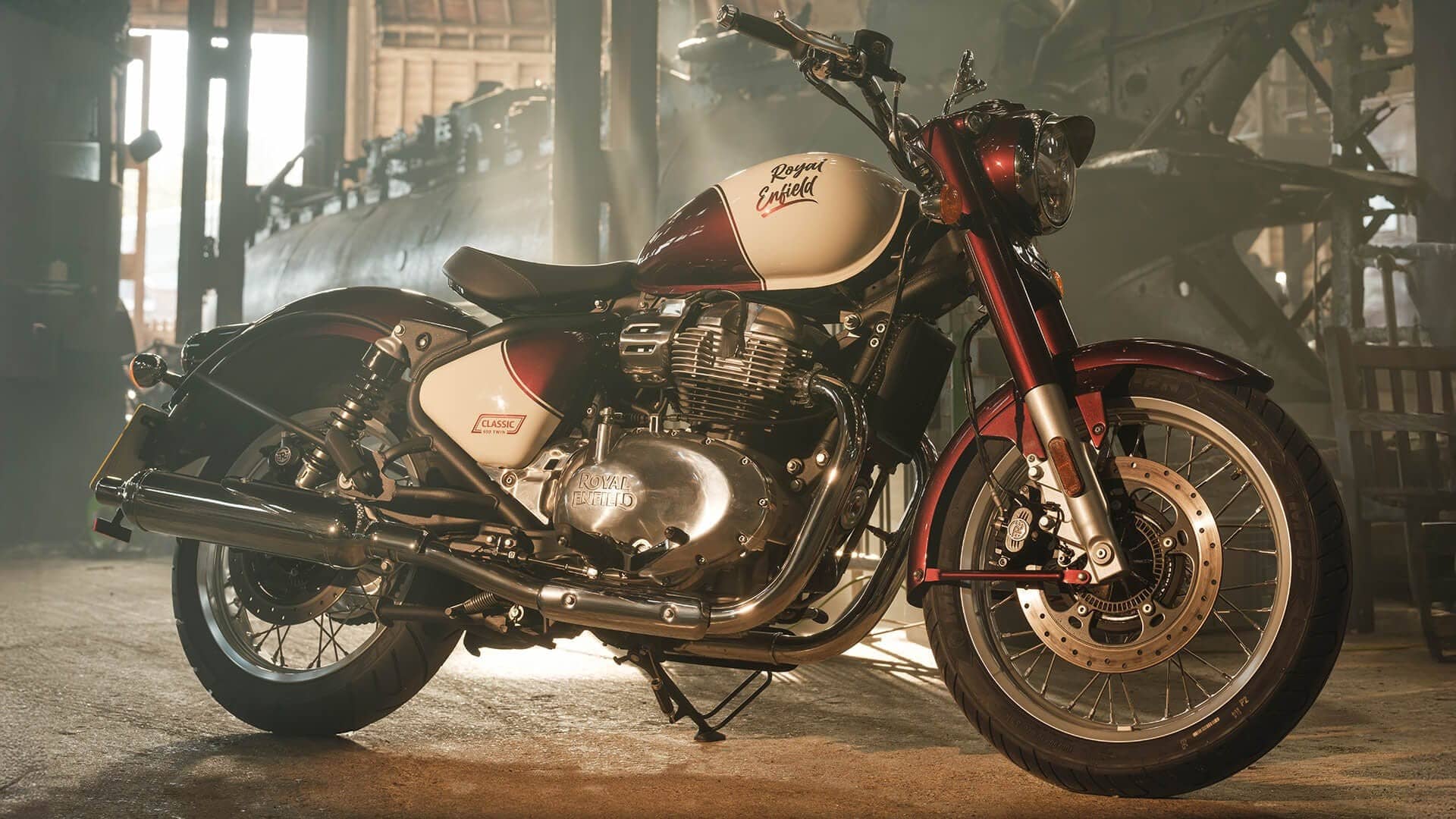 Royal Enfield Classic 650 in red and cream parked in a workshop