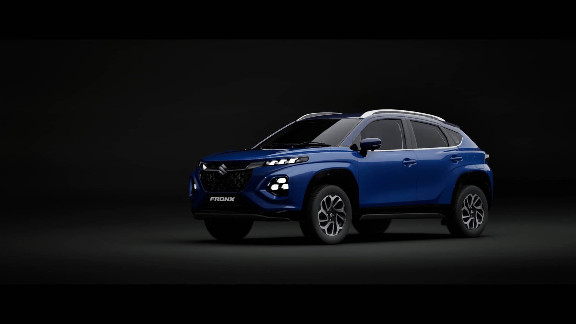 A blue Maruti Suzuki Fronx crossover with a black roof seen from the front three-quarter angle in a dark studio
