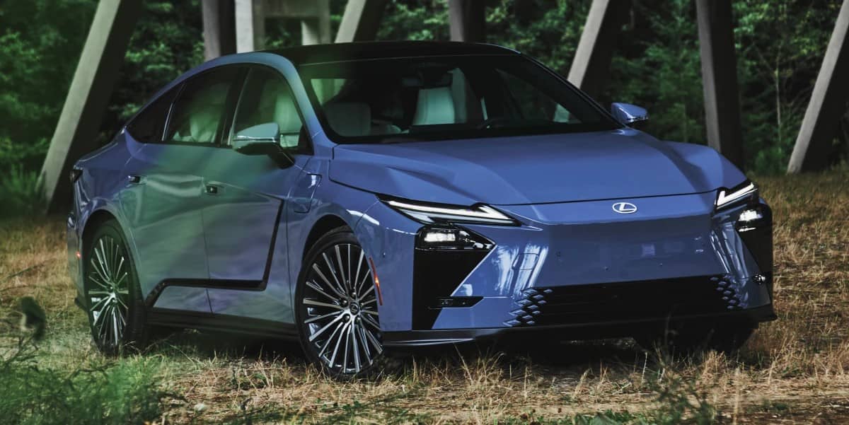 A blue Lexus ES sedan parked on grass