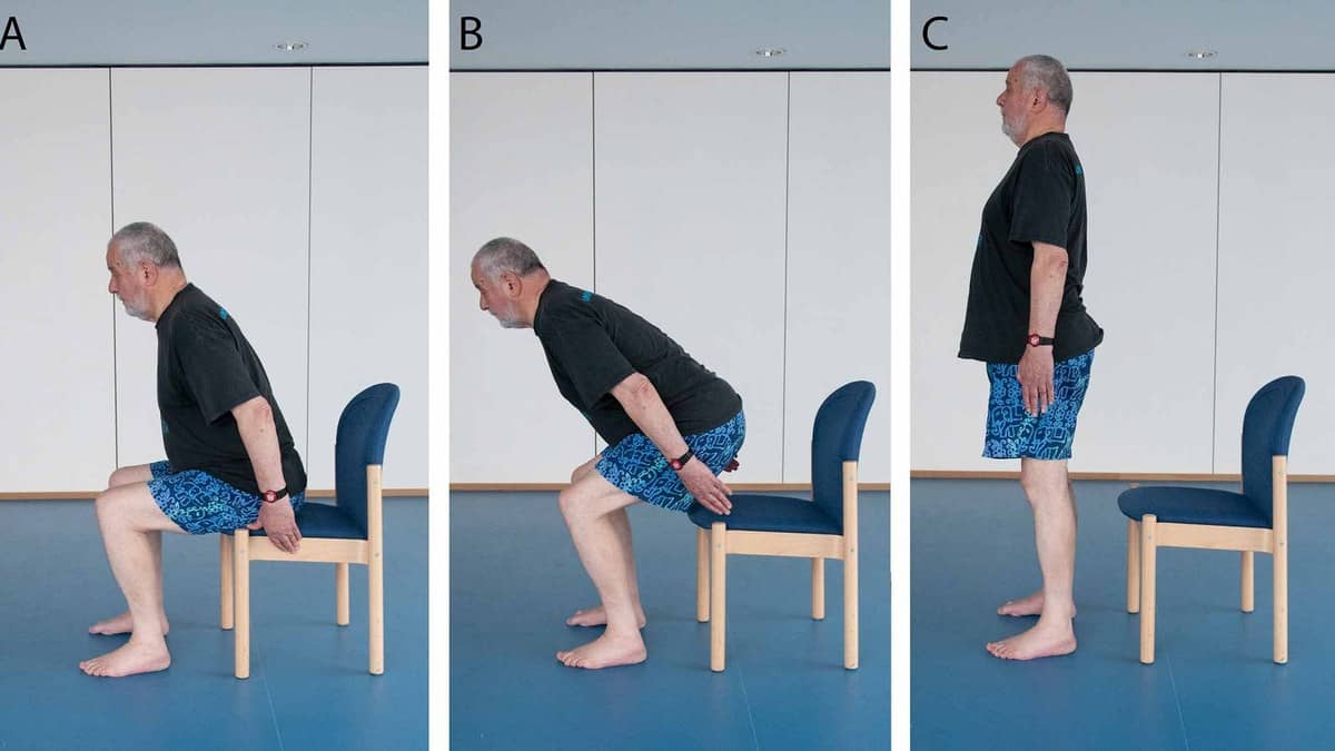 Three photos show a man sitting on a chair, leaning forward to rise, and standing upright during a strength exercise.