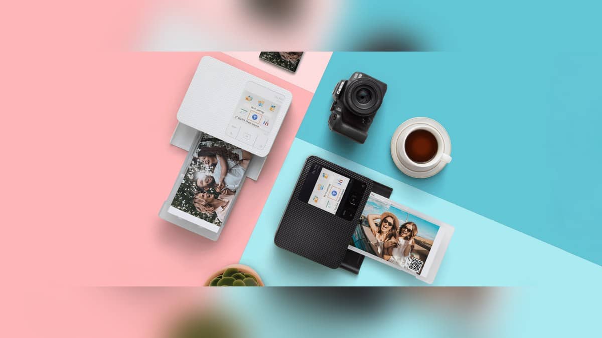 Landscape Canon SELPHY CP1500 banner showing white and black photo printers producing photographs