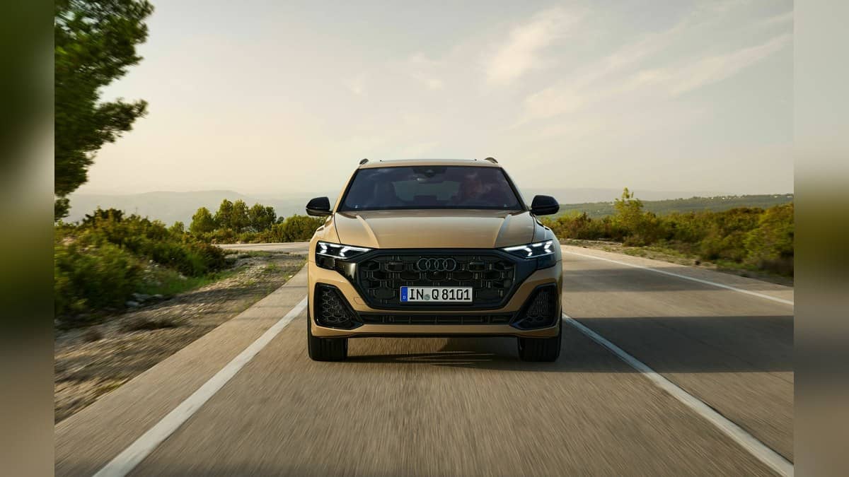 Official landscape photograph of the Audi Q8 in Sakhir Gold Metallic in motion