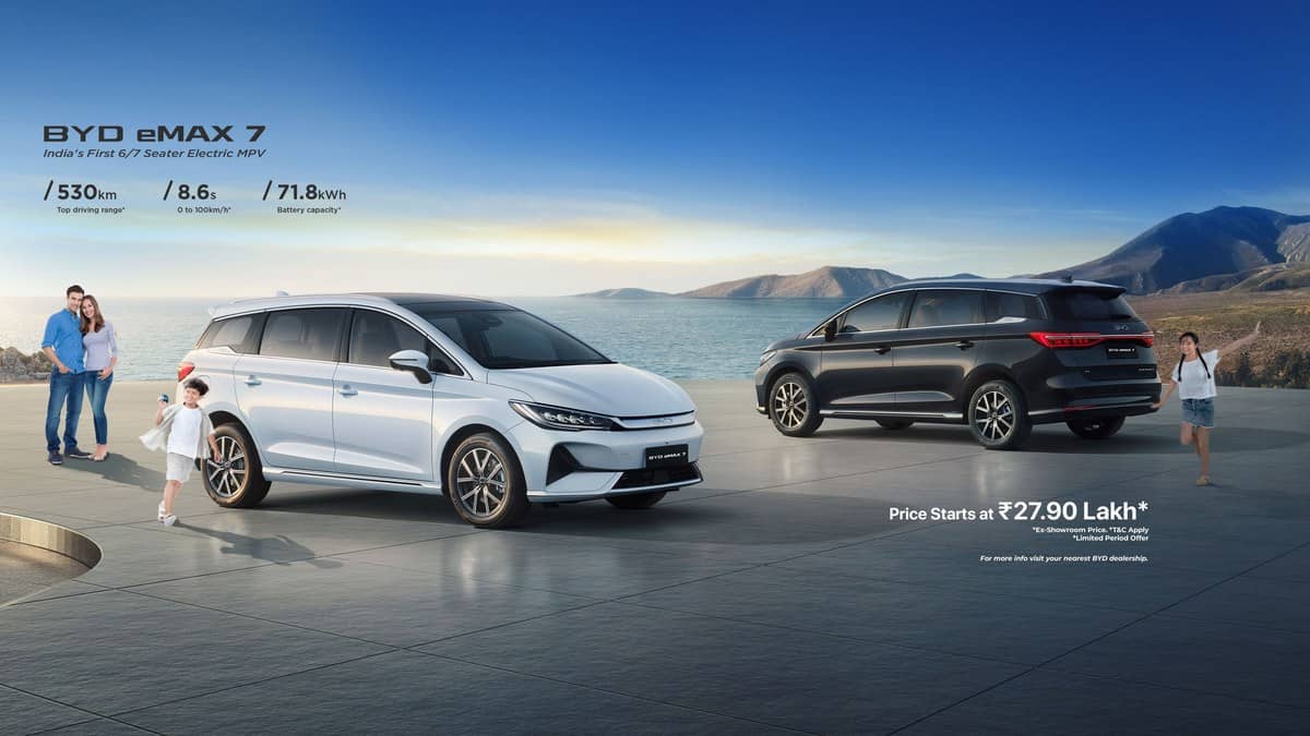 White BYD eMAX 7 with a family beside the water in an official landscape banner