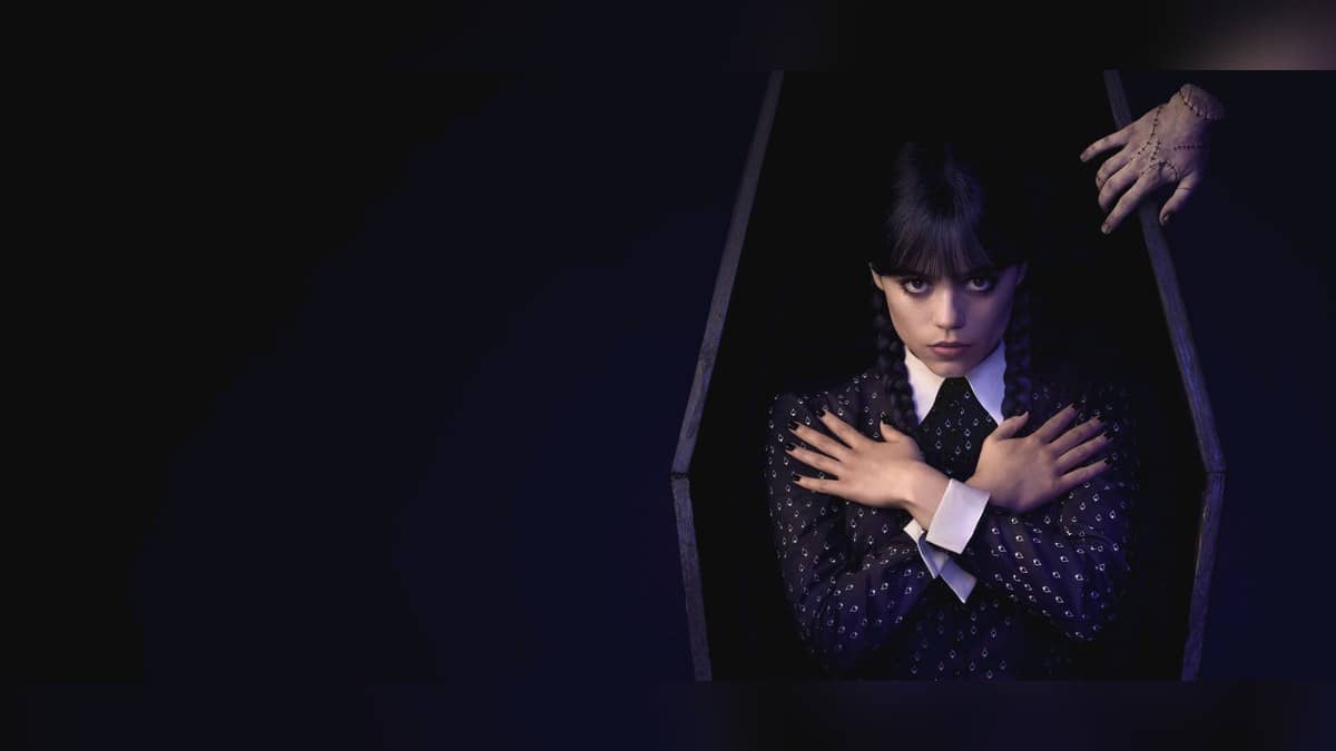 Jenna Ortega as Wednesday Addams appears beside Thing in the official Netflix promotional artwork.
