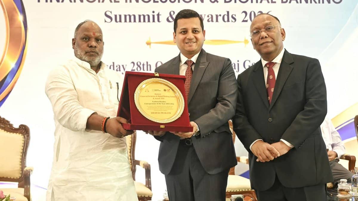 Dhawal Prakash Agrawal being presented with a fashion retail award on stage at the summit in Varanasi.
