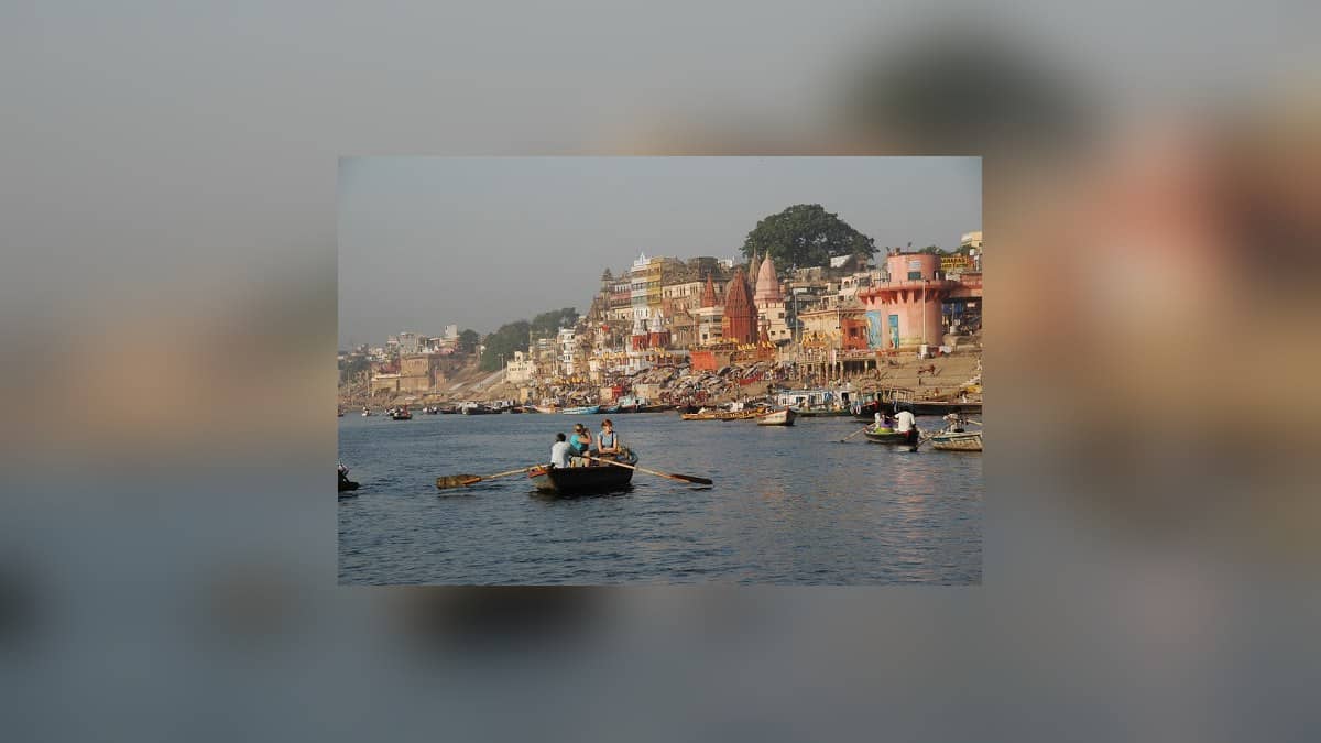 A daytime photograph from the Varanasi district website shows boats on the Ganga beside the city ghats.