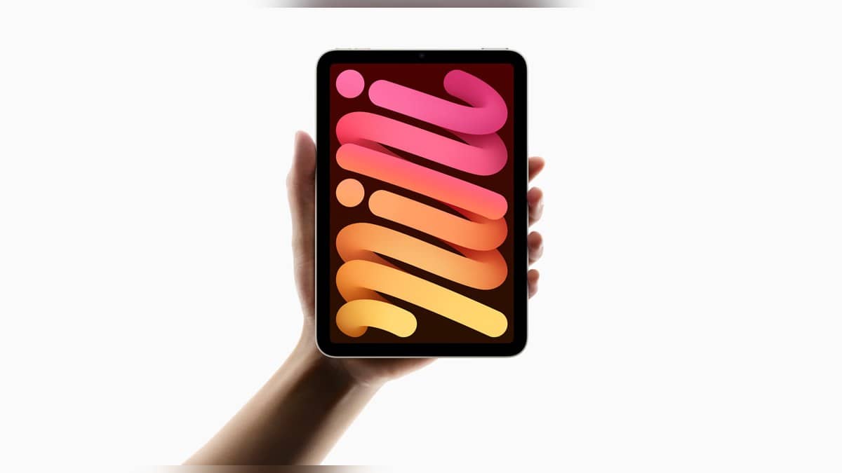 Landscape official photograph of a hand holding the iPad mini A17 Pro